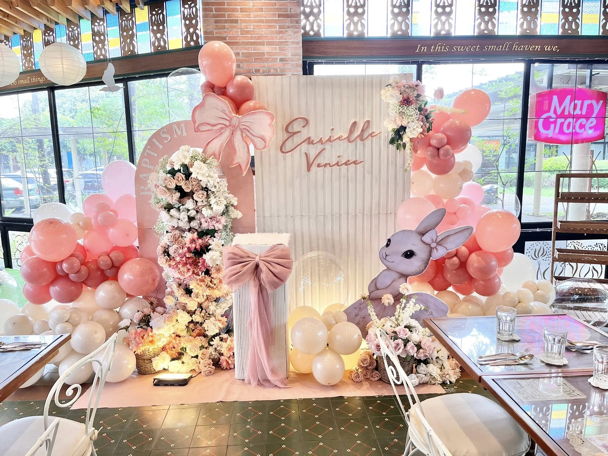 Eurielle Venice baptism setup — pink florals and balloon arch